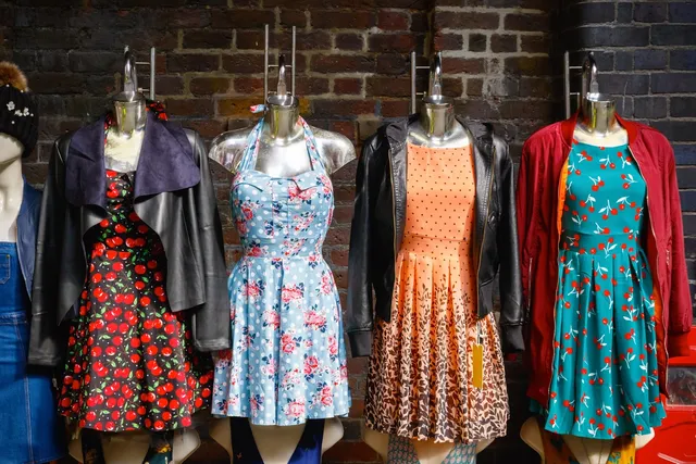 A row of mannequins wearing dresses and jackets.