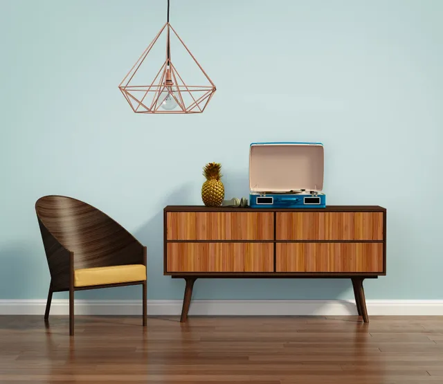 A chair and a table in front of a wall.