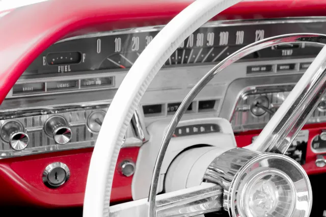 A close up of the steering wheel and dashboard